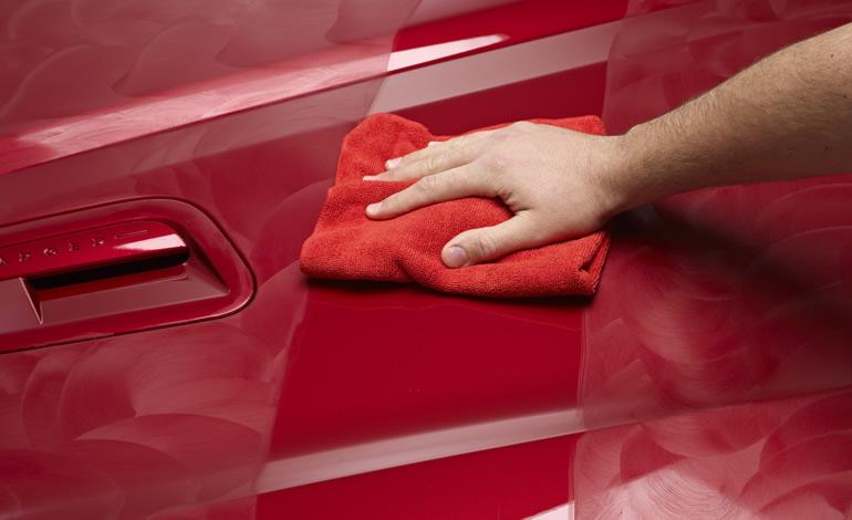 Hand polishing red car paint